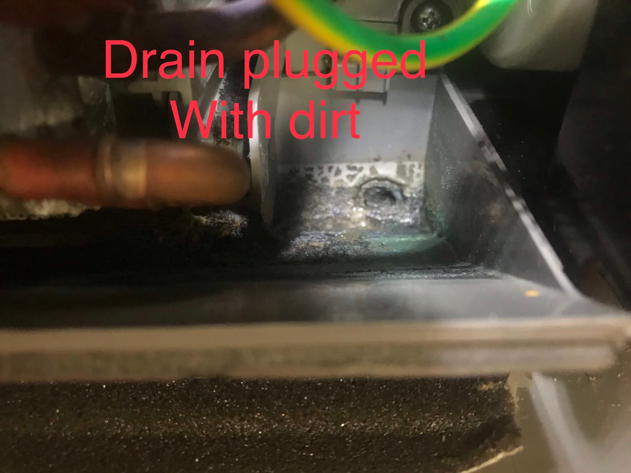 Mini-split drain plug clogged with dirt